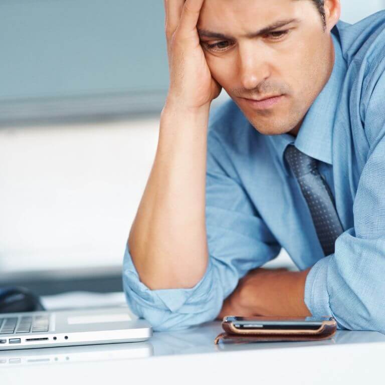Why Experienced Estate Agents Are Struggling for Leads. A frustrated estate agent at his desk