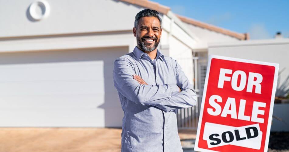 Real Estate Feast and Famine Cycle. Estate agent at a house he sold.