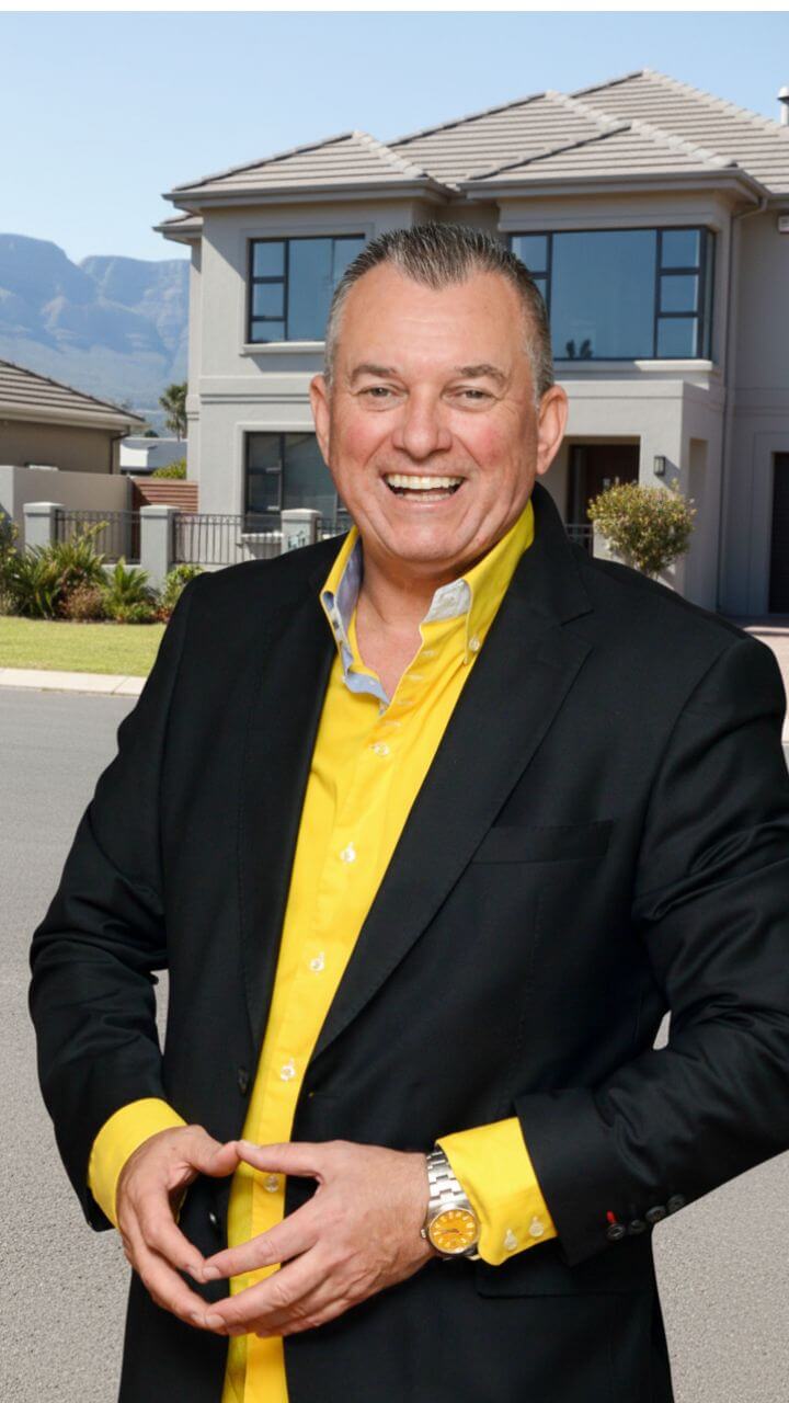 Brackenfell real estate expert. Andre Swart standing in front of a house in Brackenfell he sold
